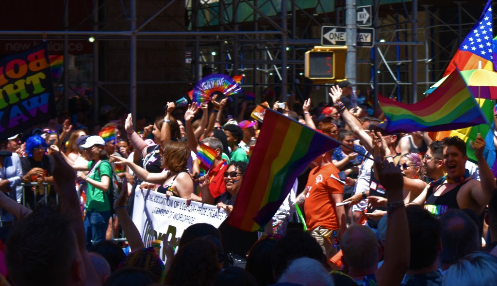 A group of people standing in front of a crowd

Description automatically generated