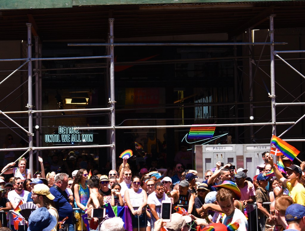 A group of people standing in front of a crowd

Description automatically generated